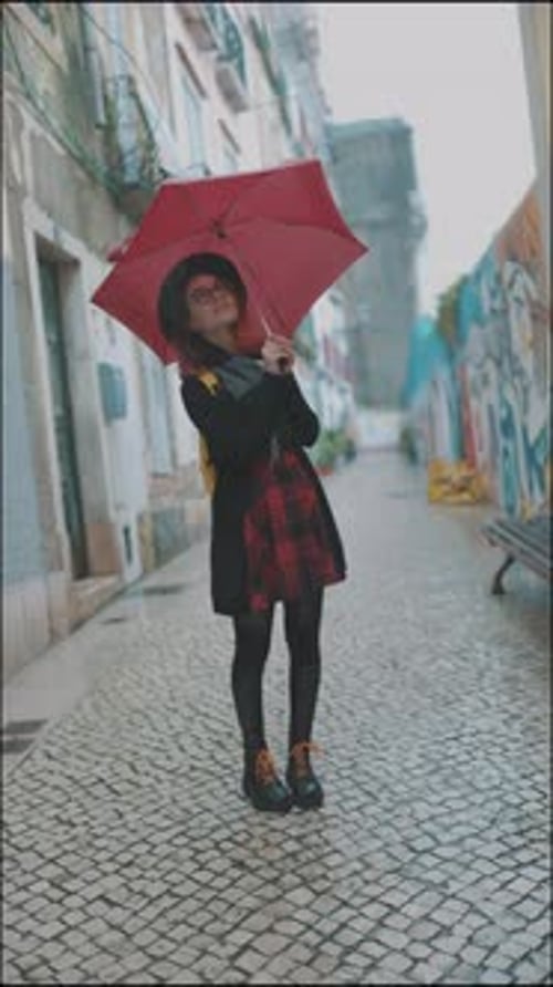 Teen Posing with Umbrella on Wet City Street