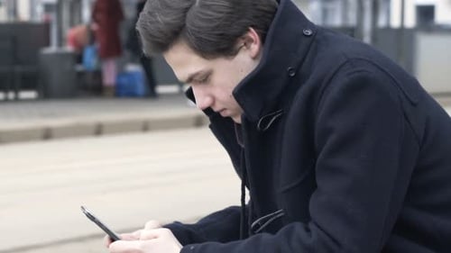 Young Teenager Surfing Internet, Texting on Smartphone in the City Adolescent