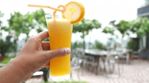 Refreshing Orange Juice Drink Outdoors in Daytime