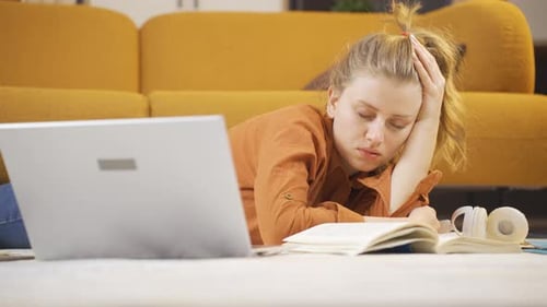 Woman Asleep Studying on Living Room Floor