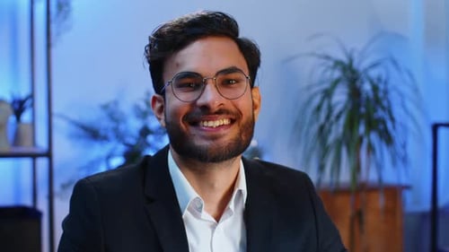 Portrait of Happy Smiling Bearded Indian Business Man at Home Office Look Away Turn Head at Camera