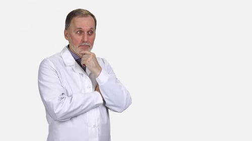Mature Man in Lab Coat Points to Side