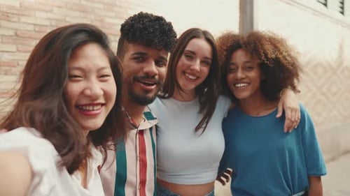 Happy, lovely multiethnic young people posing for the camera taking selfie