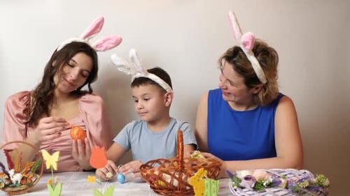 Family Decorating Easter Eggs Wearing Bunny Ears