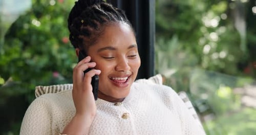 Smiling Woman Talking on Phone Indoors by Window