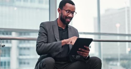 Man in Suit Using Tablet Inside Building