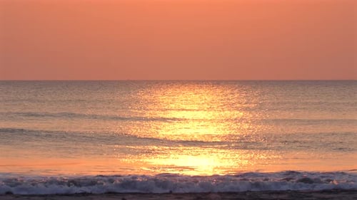 Serene Ocean Sunset View with Vibrant Orange Hues Reflecting on Calm