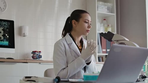 Laboratory Worker Examining Samples in Microscope when Conducting Research