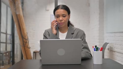 Phone Talk with Customer by African American Businesswoman