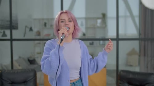 Lovely Positive Woman Singer with Microphone Performing Upbeat Song Indoors