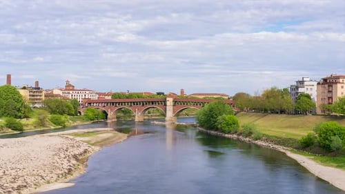 Ponte Coperto (covered bridge) in Pavia at cloudy day, Lombardy, italy. Timelapse 30 fps.
