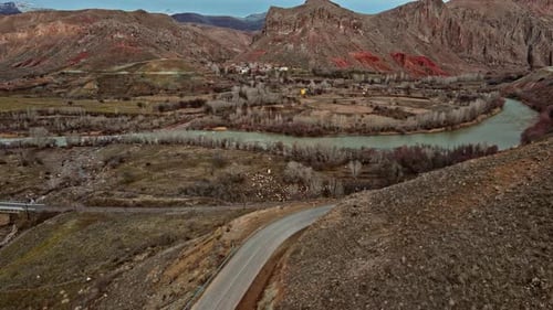 Aerial View of River Valley with Rural Village and Grazing Sheep