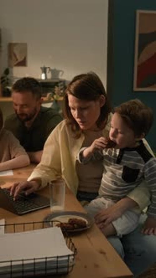 Woman and Child Using Laptop at Table