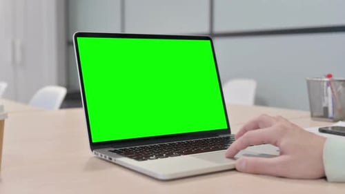 Close up of Young Man Using Laptop with Green Screen