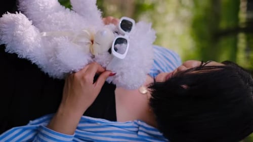 Mother and child together in the park outdoors, lying in the grass. Motherhood happiness concept. Da