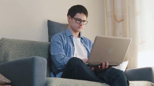 Young Adult Working on Laptop at Home