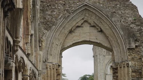 Glastonbury Abbey ruins, detail of a wall with gothic arch 4k slow motion