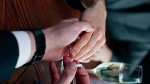 vertical video close-up of a woman on a date with a man who proposes to her and puts a wedding ring