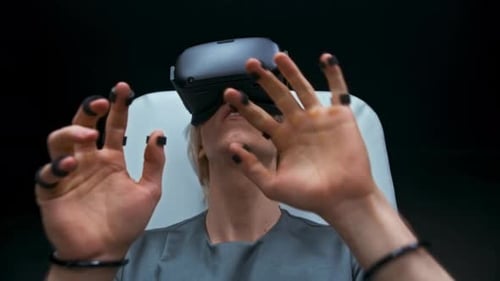 Young Adult Using VR Headset in White Chair