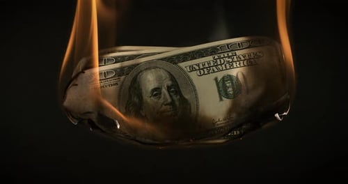 USA dollar bill money is burning in the fire, the concept of the economic crisis of inflation and