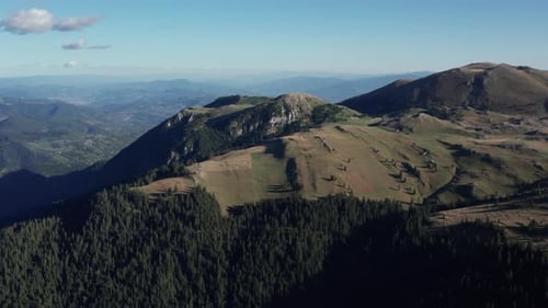 Aerial Mountainscape with Rolling Meadows, Forest Slopes and Distant Valleys