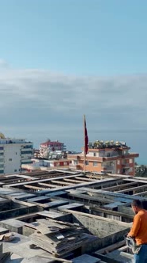Vertical Video Construction Site Activity with Multiple Workers and Equipment in Use