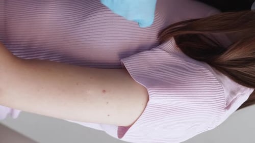 Bandage applied by medical professional in blue gloves