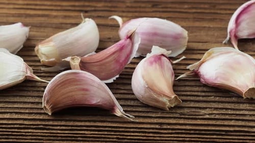 Garlic Cloves Displayed on Rustic Wooden Surface