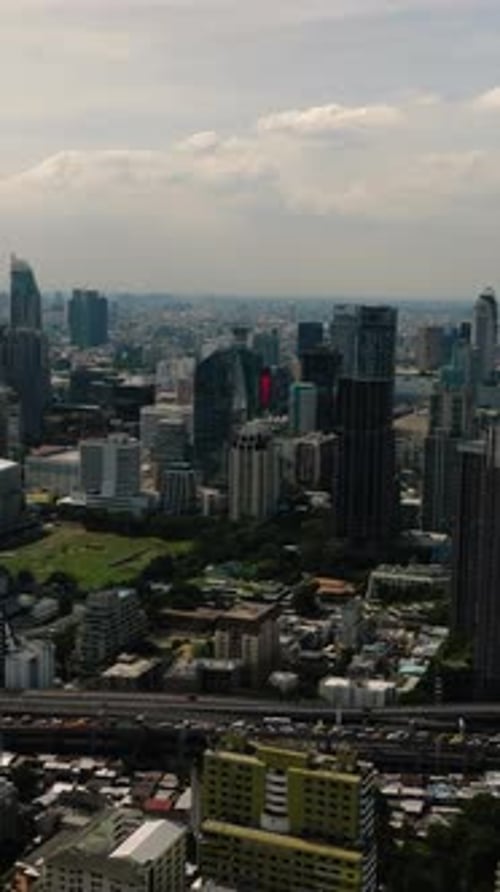 Cityscape Featuring High Rise Structures and Green Zones Bangkok Thailand