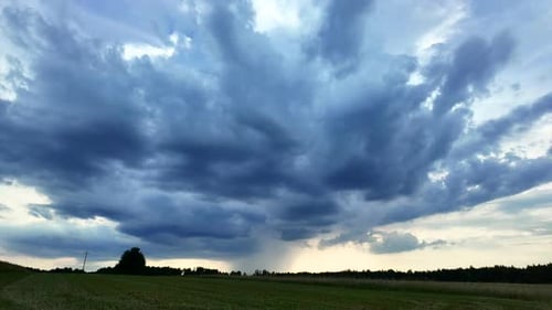 Dramatic Rain Clouds Over Rural Green Field