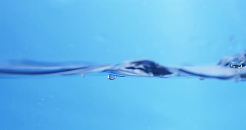 Transparent Water Droplets in Motion. Clear Fluid in a Flowing, Circular Pattern.