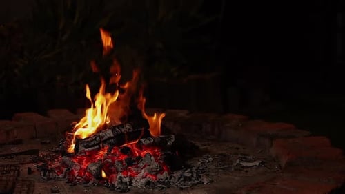 Glowing Campfire Burning Brightly at Night