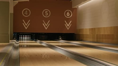 Sets of Pins Set Up in Wooden Lanes in Bowling Alley