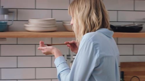 Woman Cooking, Offers Food to Man, Couple Kisses