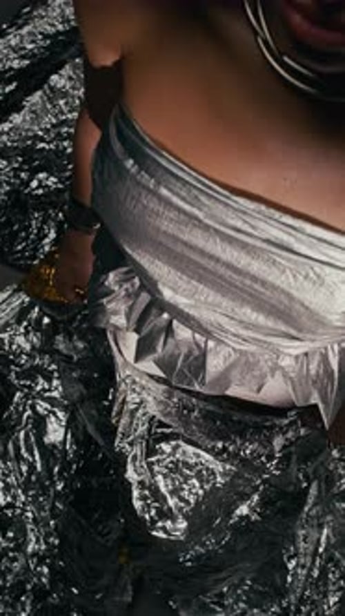 Stylish Woman Posing with Silver Dress and Jewelry