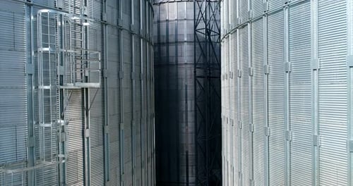 Large metal silo for storing grain. Modern industrial plant. Granary.