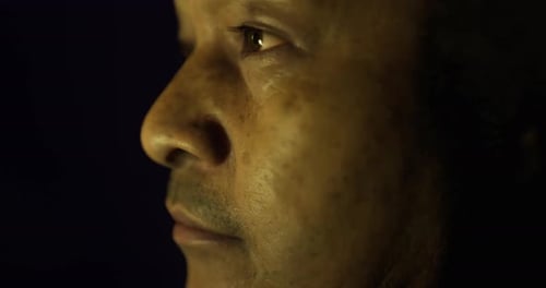 Profile View of a Man in Deep Thought with Soft Lighting