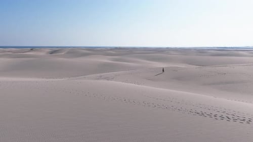 Aerial View of a Remote Desert Landscape in Yemen Featuring Sand Dunes and a Lone Walker