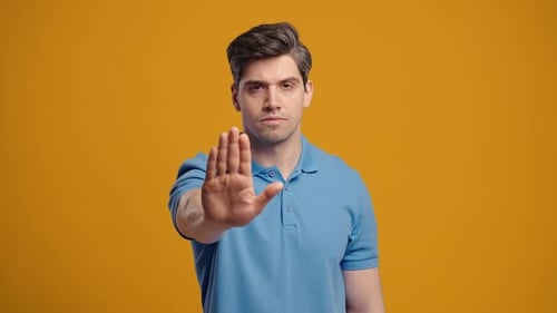 Young Adult Hand Raising a Stop Sign