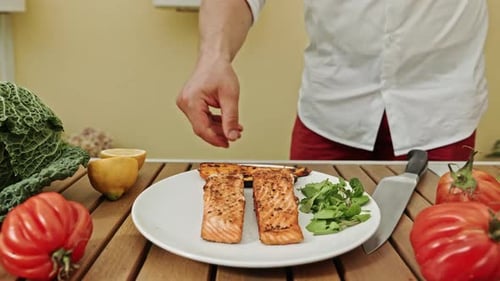 Chef Plates Salmon with Vegetables and Lemon