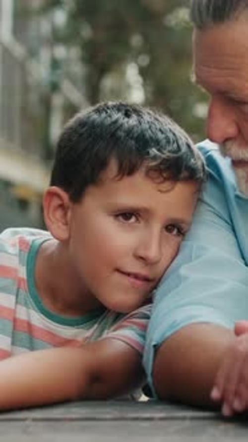 Grandfather and Grandson Bonding at Picnic Table