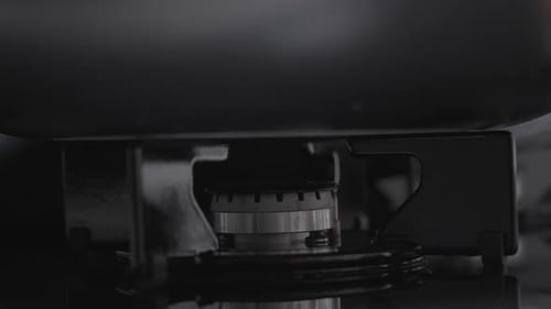 Close Up of Gas Burner Igniting on Stovetop