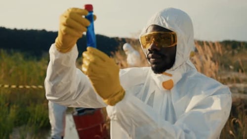 Scientist Examining Samples in Environmental Protective Gear
