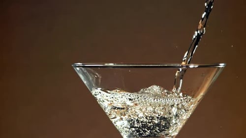 Clear Liquid Being Poured Into Glass