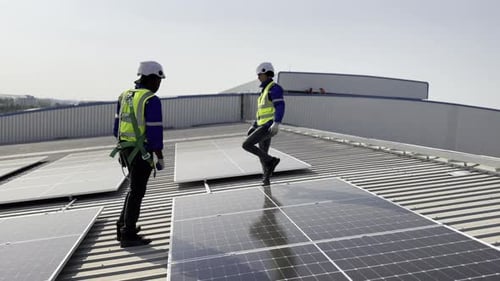 Technician installing solar cell. Installation and maintenance of solar cells on rooftop.
