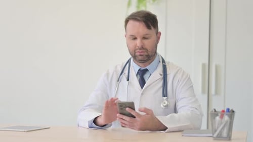 Doctor Uses Smartphone in Bright Office Setting