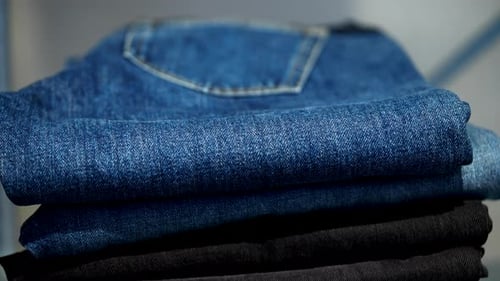 Stack of Neatly Folded Denim Jeans Close Up