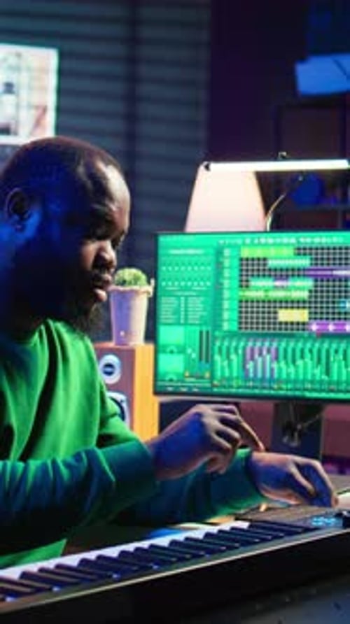Man Composing Music at Recording Studio Keyboard