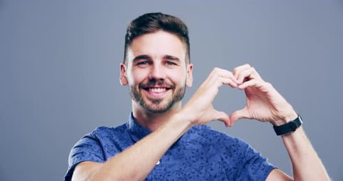 Man Makes Heart Shape with His Hands