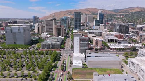 An Aerial View of a Vibrant Urban Cityscape Surrounded By Majestic Mountains in the Background